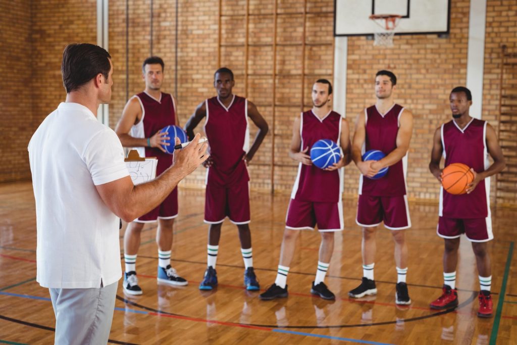 Basketball coach interacting with players