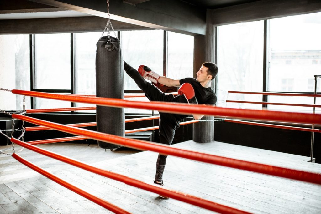Kickboxer training with punching bag