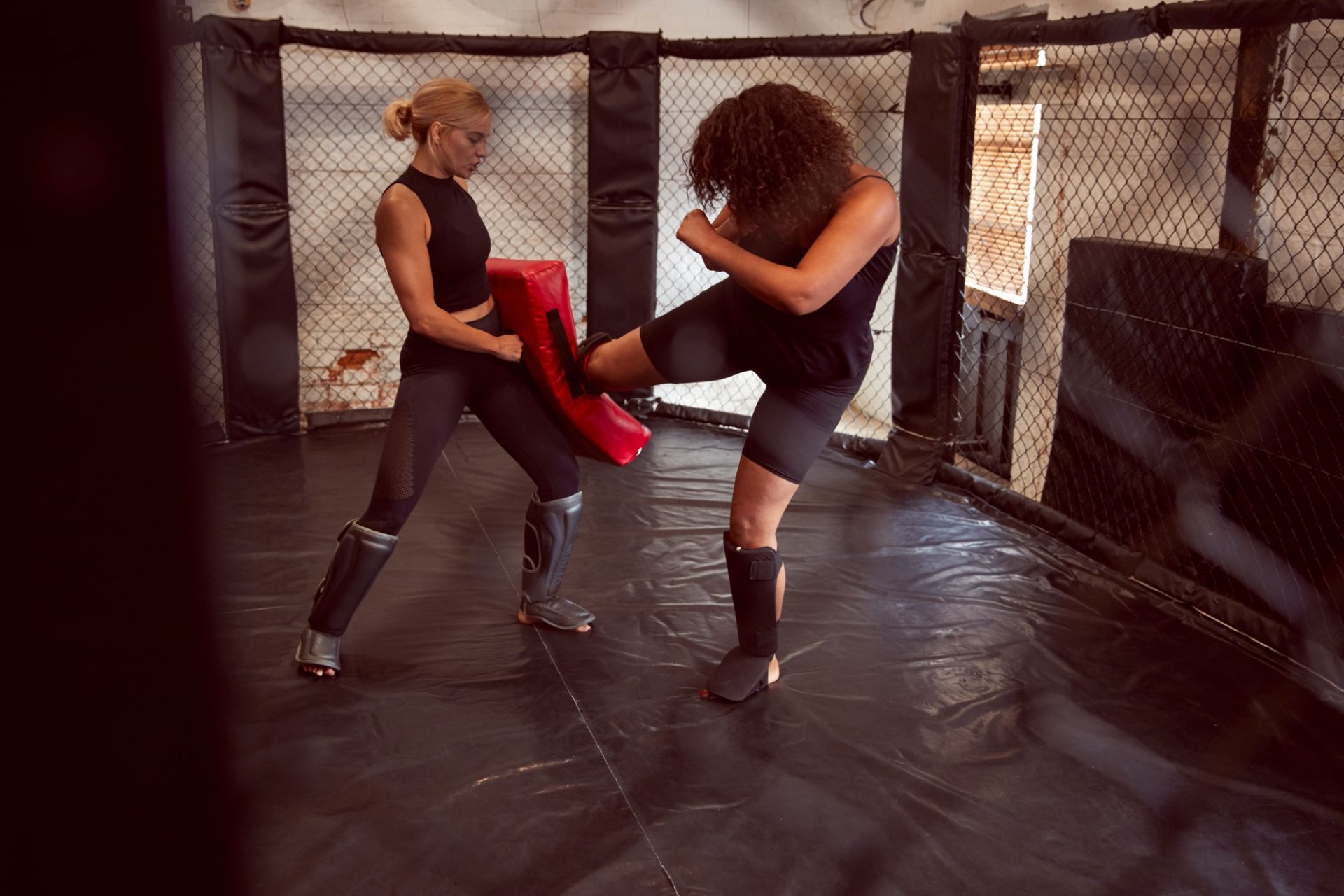 Two Female Mixed Martial Arts Fighters Kick Boxing Training In Gym